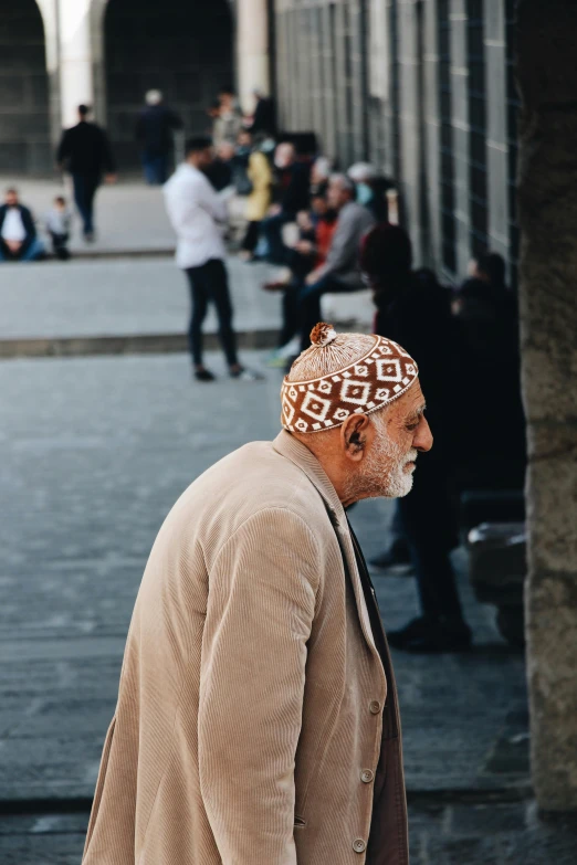 a man walking down the street with some people