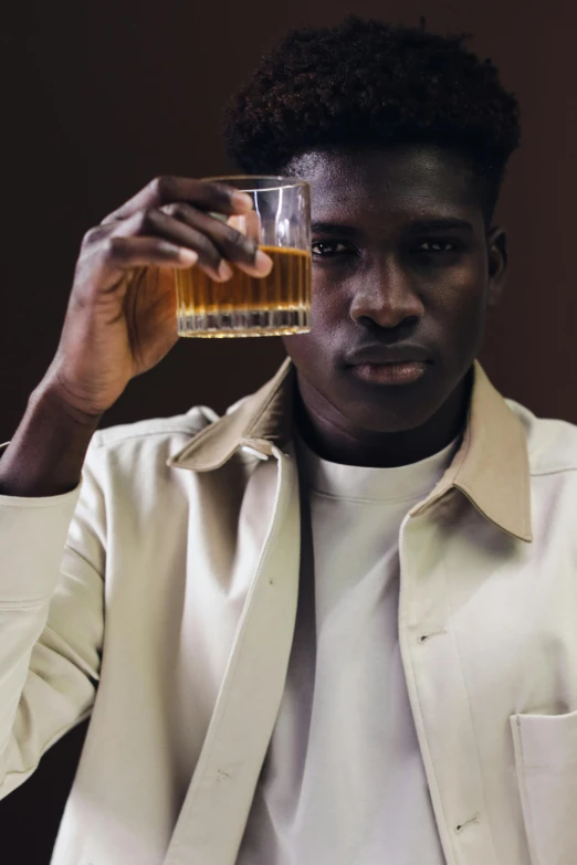 a person holds a glass of water to his face