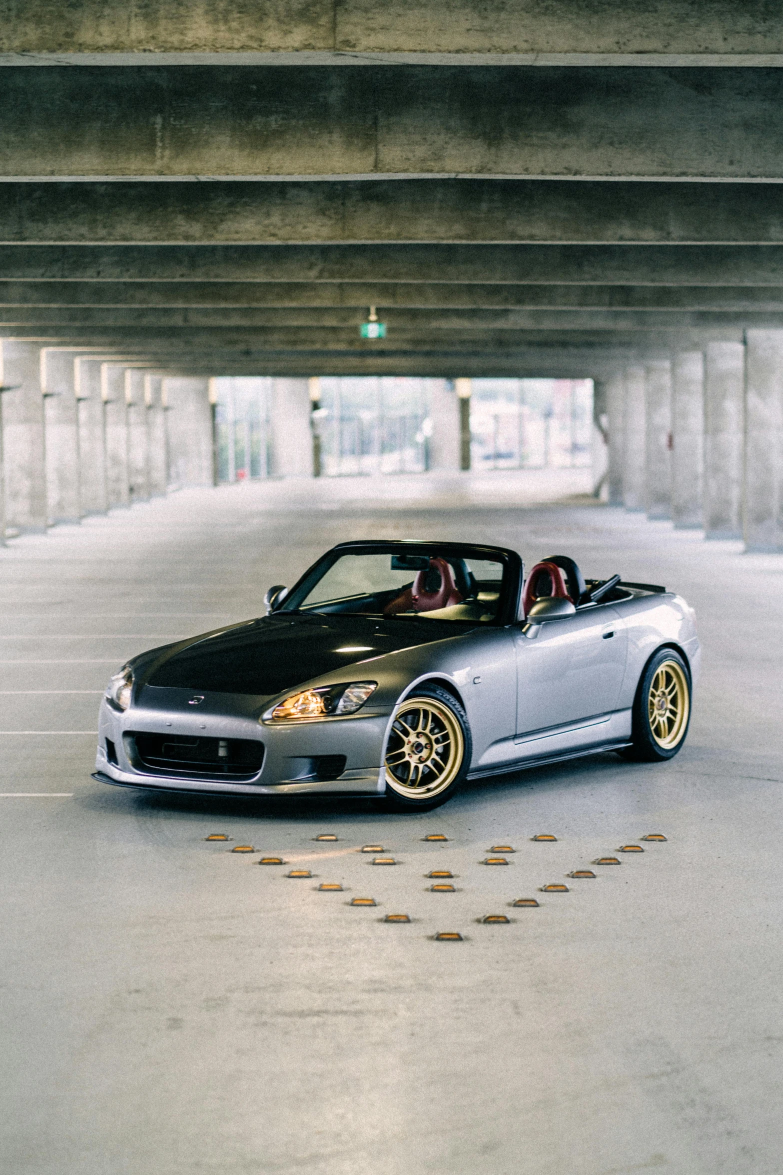 a convertible sits in the middle of a parking lot