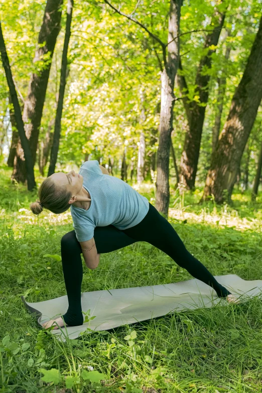 a woman doing yoga poses in the grass