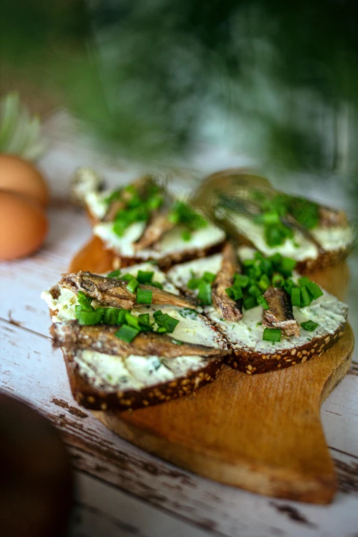 two pieces of bread with green toppings on it