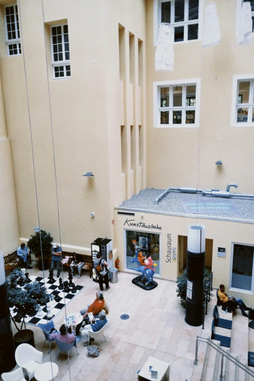an empty courtyard with lawn chairs and umbrellas