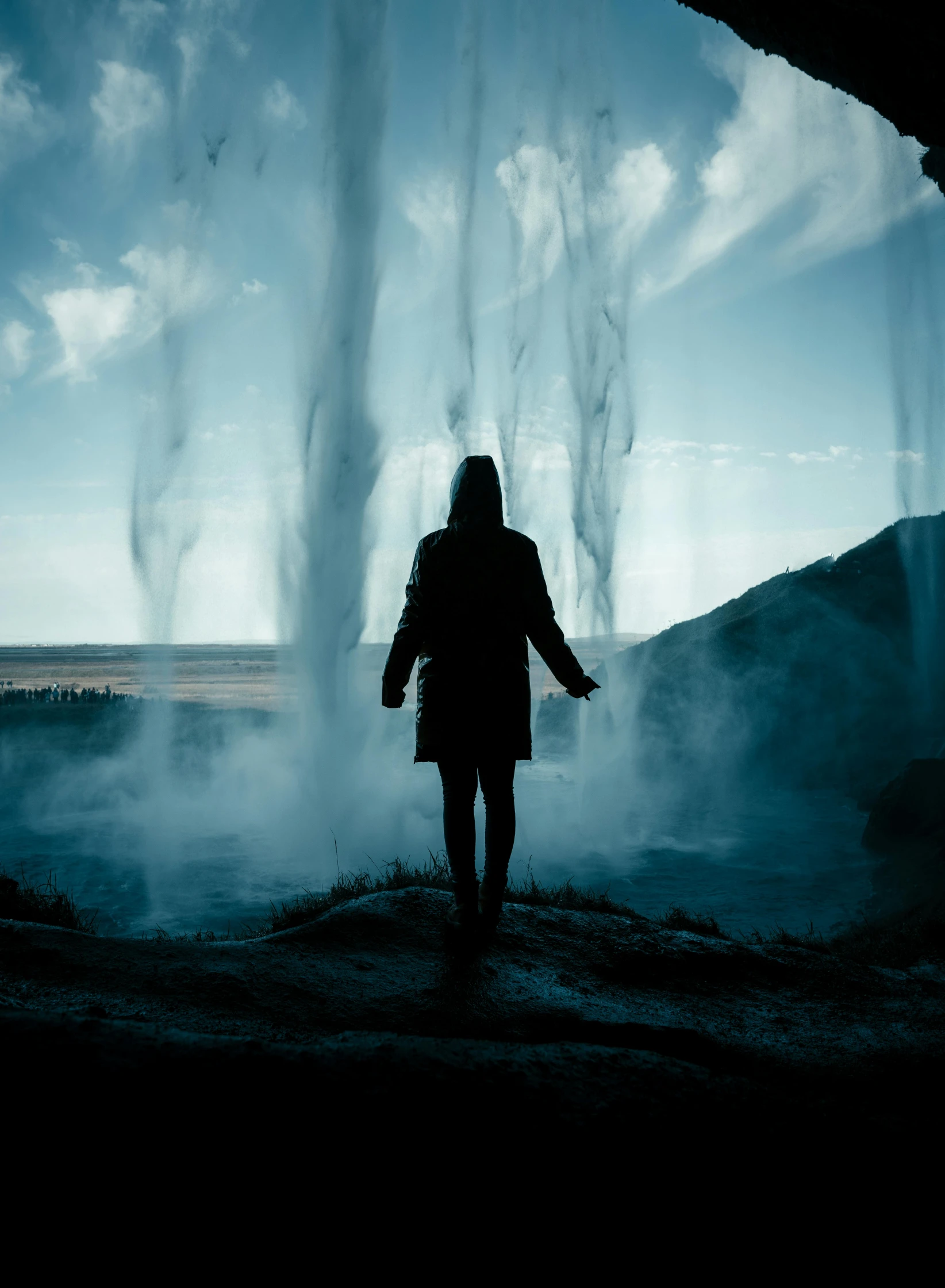 a person standing in front of steam coming out of the ground