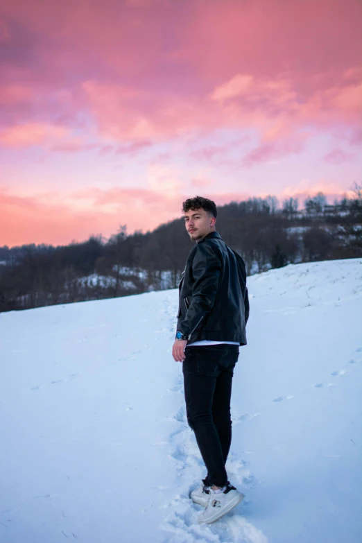 the young man is on his snowboard in the snow