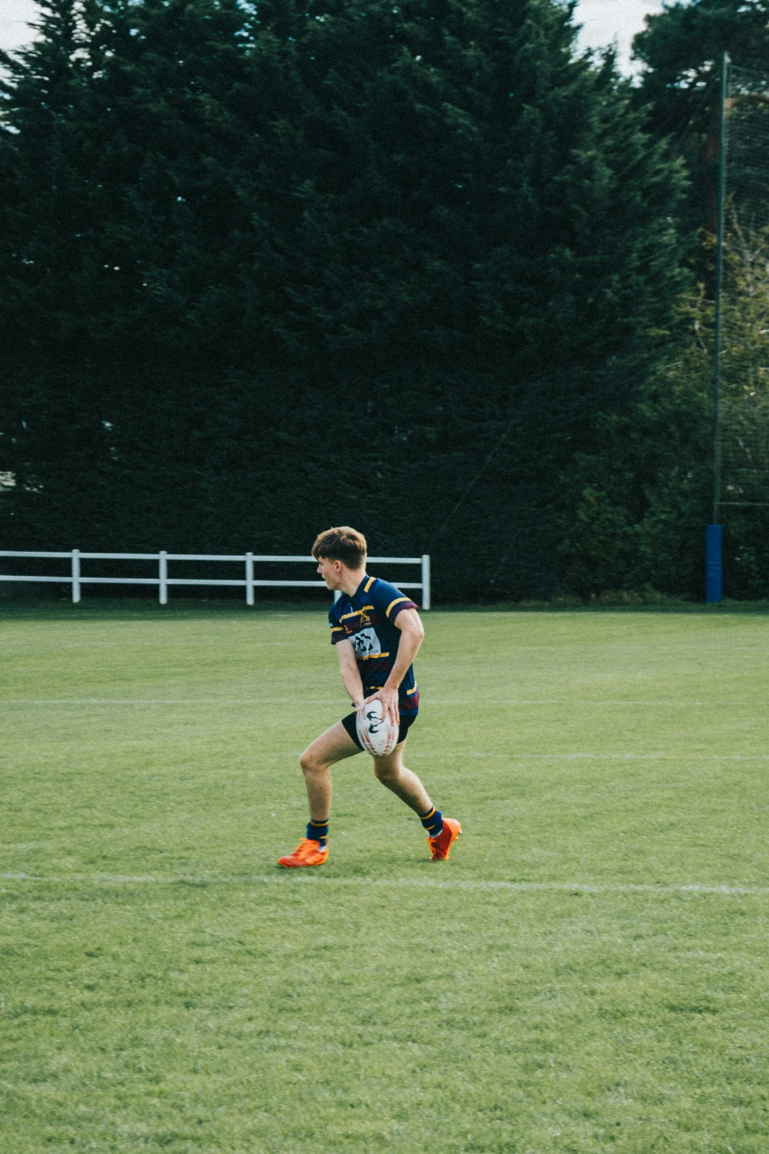 a  running on grass wearing a uniform