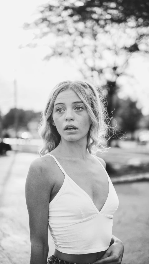 a young woman is posing for a black and white picture