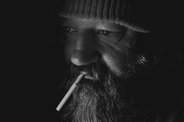 black and white pograph of a man with a pipe in his mouth