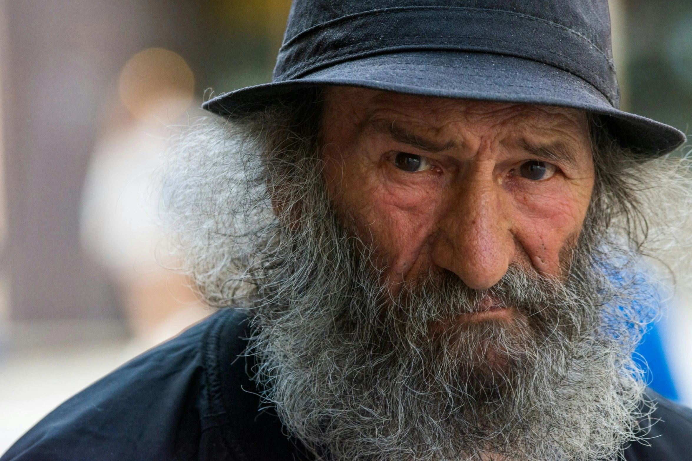 an old man with long beard wearing a hat