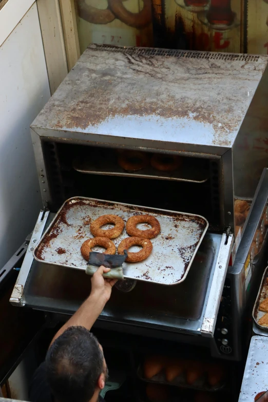 a person puts a piece of dough into an oven