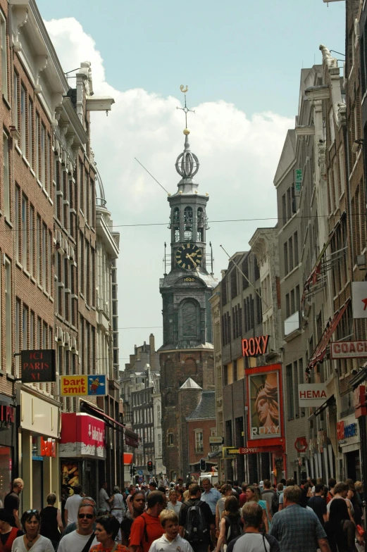 a large crowd of people walking down a street