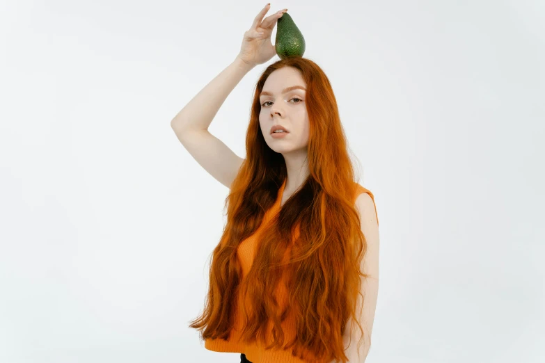 a red haired woman with long hair and a green hair brush