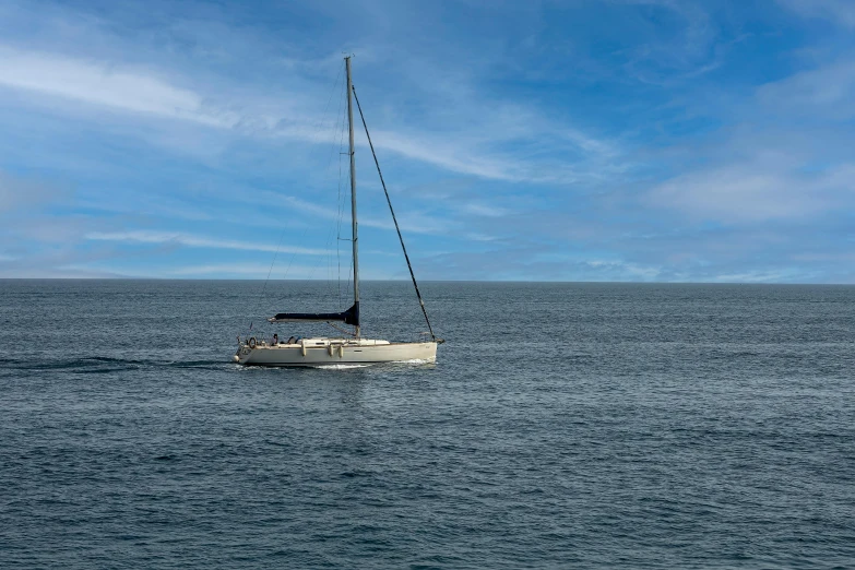 the sail boat is in the open ocean on a sunny day