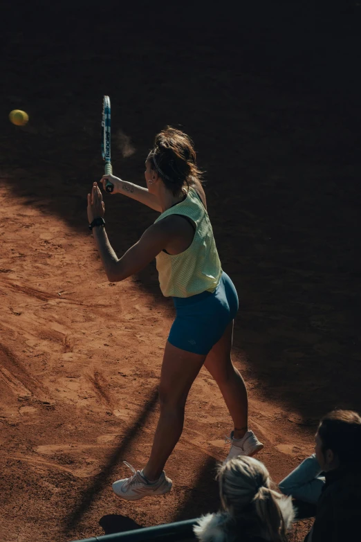 a woman swinging a racket at a ball in the air