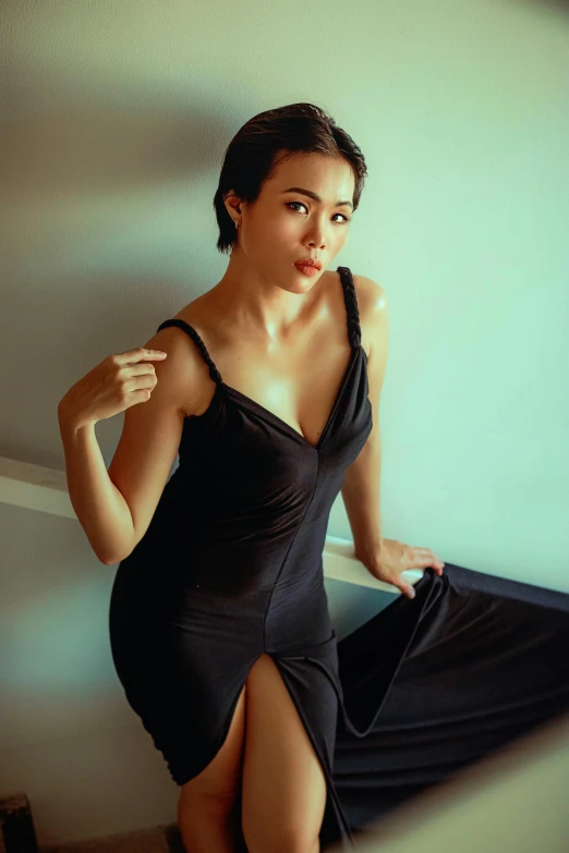 a beautiful woman in a black dress posing for a po
