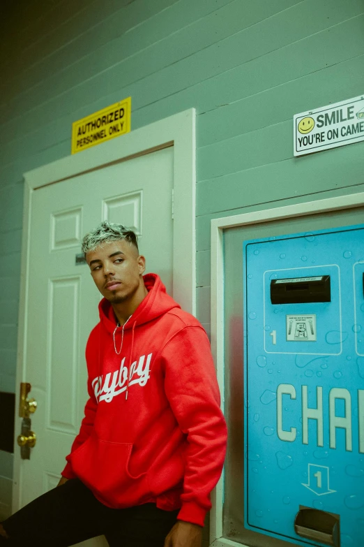 a man standing by a locker in a building