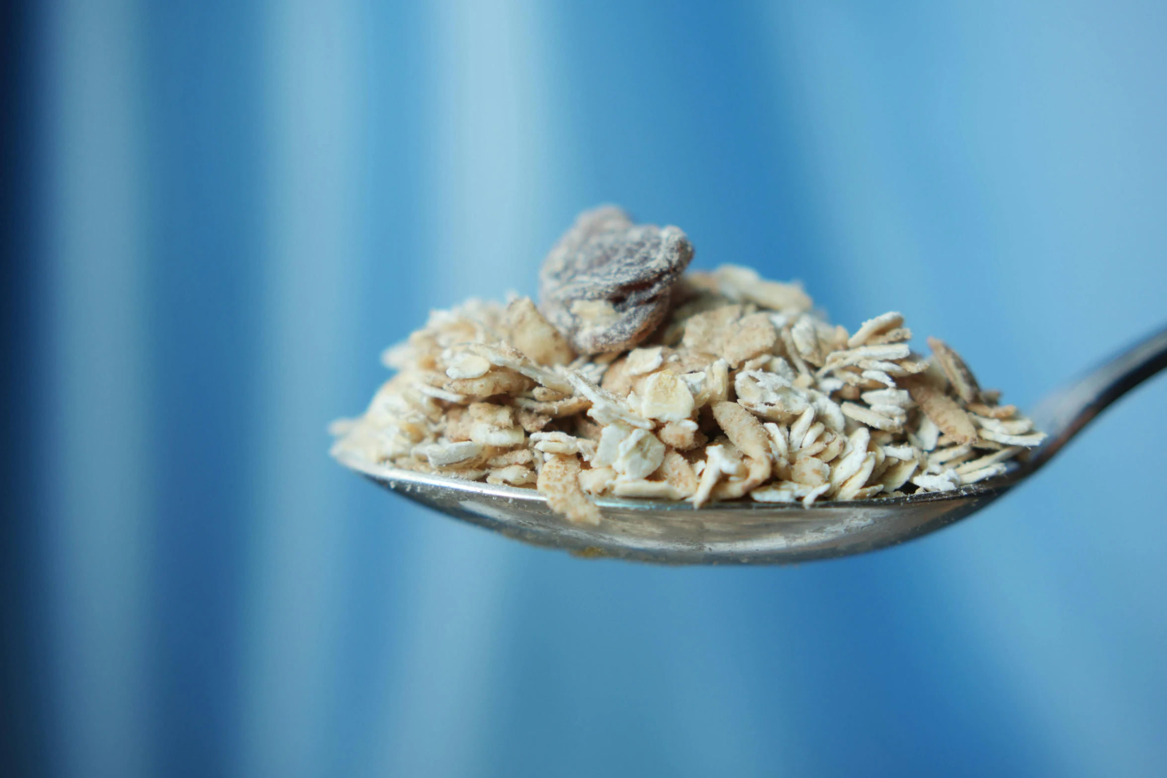 a spoon that has some kind of oatmeal on it