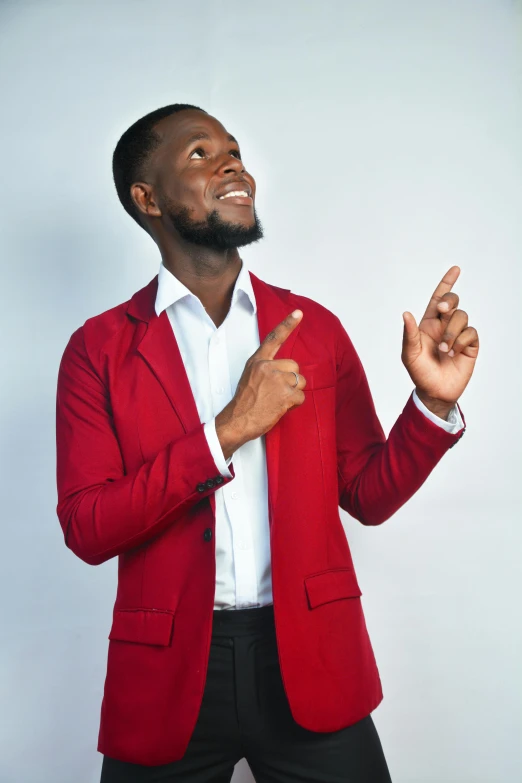 an african american man in a suit poses with his hand to the side