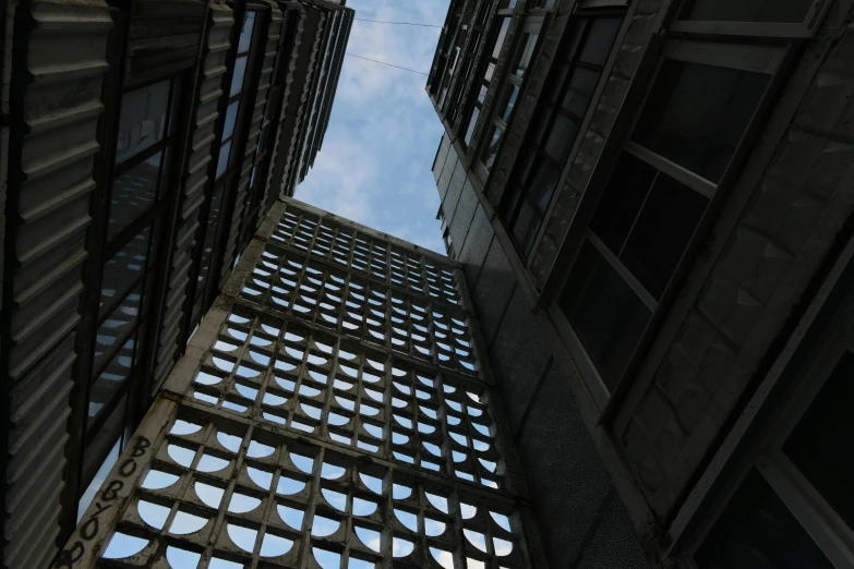 a view looking up at two tall buildings from a high angle