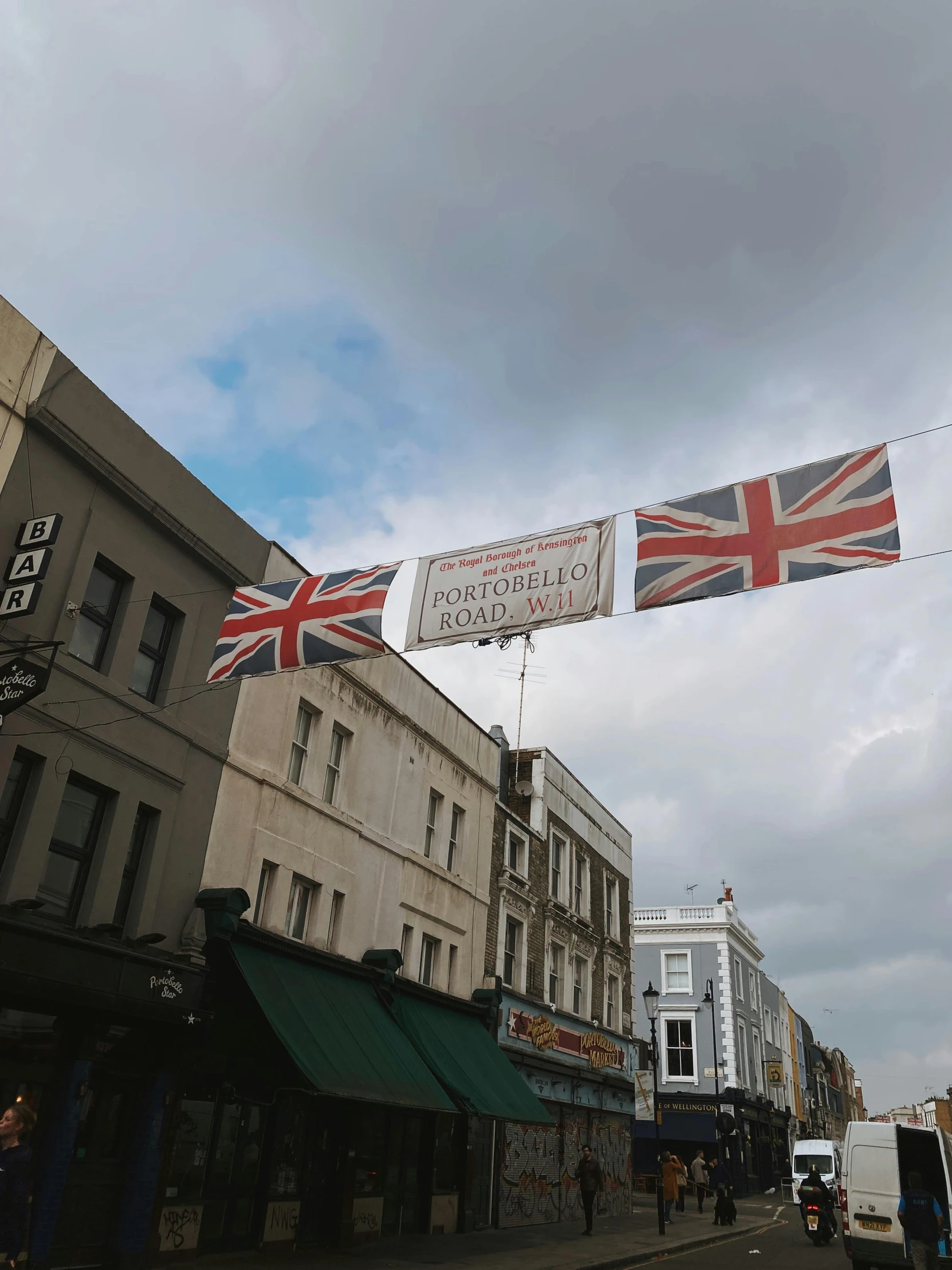 a british flag banner hangs on a building