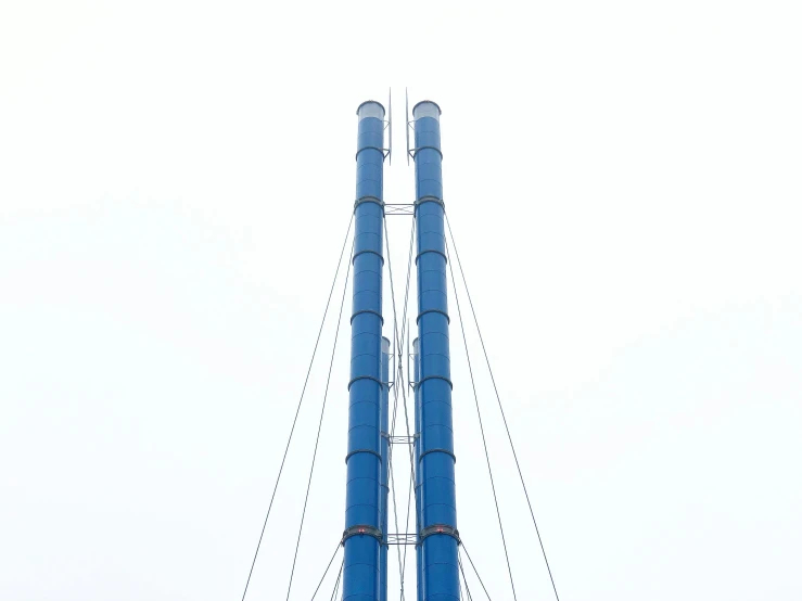 a large tower structure with blue piping at the top