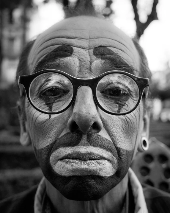 black and white pograph of an old man with glasses on