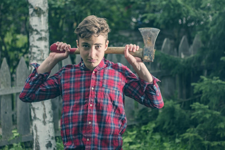 a man standing with an axe in his hand