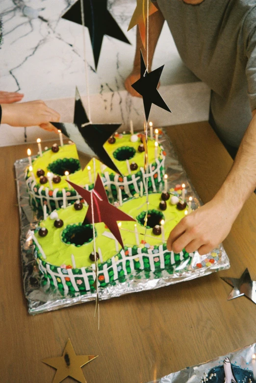 a person lighting a candle on top of a cake