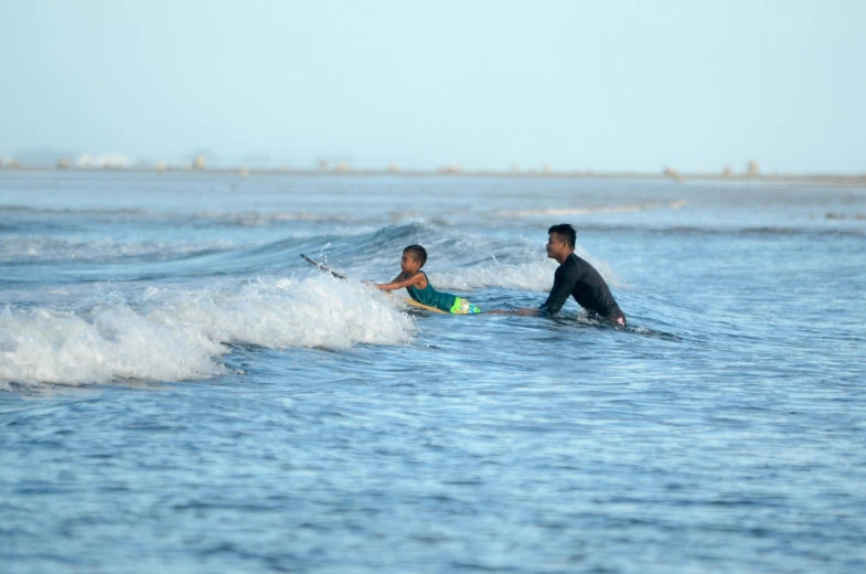 a man on a surfboard and another man surfing