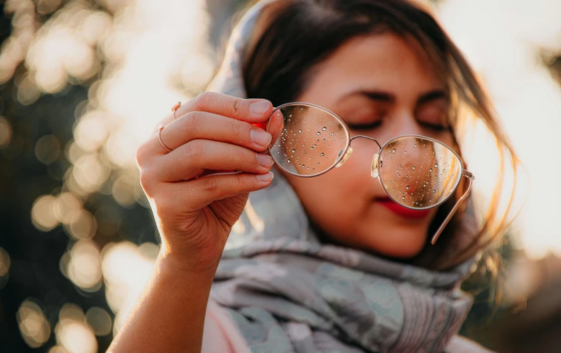 a person wearing glasses and a scarf