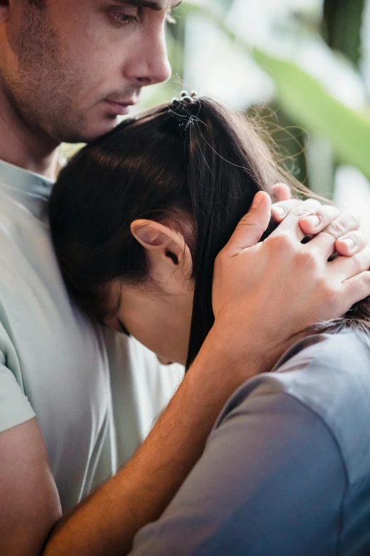 a man and woman emcing each other on their heads