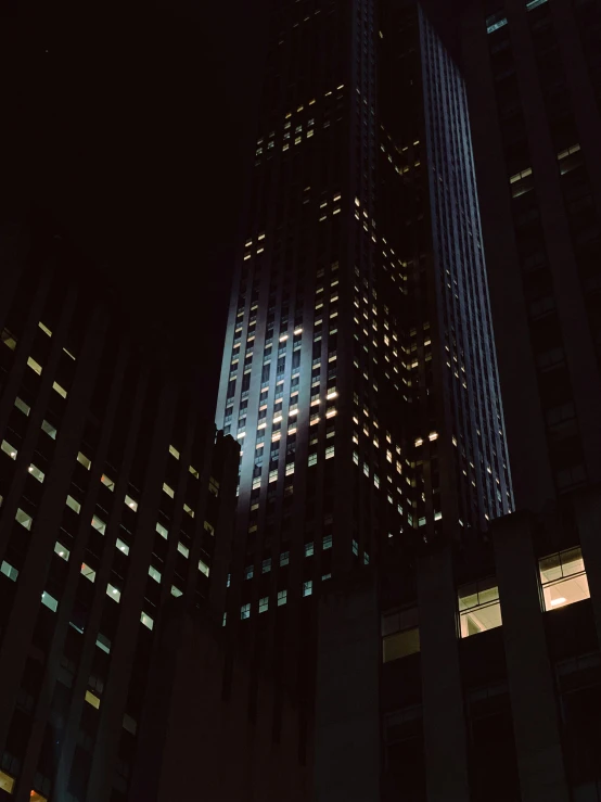 a tall building at night lit up with brightly lights