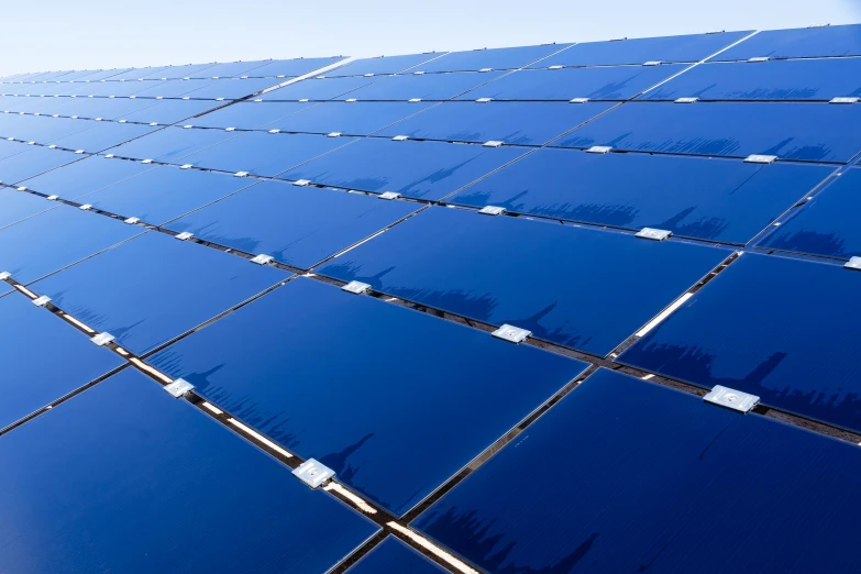 solar panels in rows against blue sky