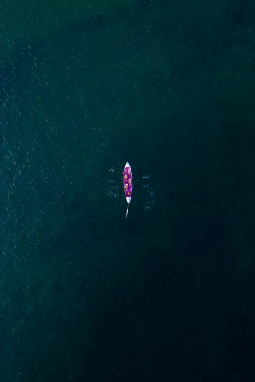 a man paddling a small boat in deep water