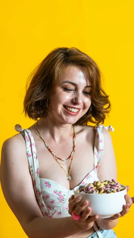 a woman in floral shirt holding a bowl of cereal