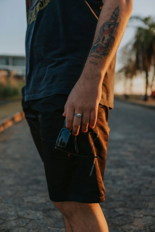 a man in shorts is on the street holding soing