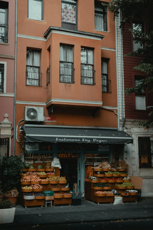 an orange building is behind some plants and boxes