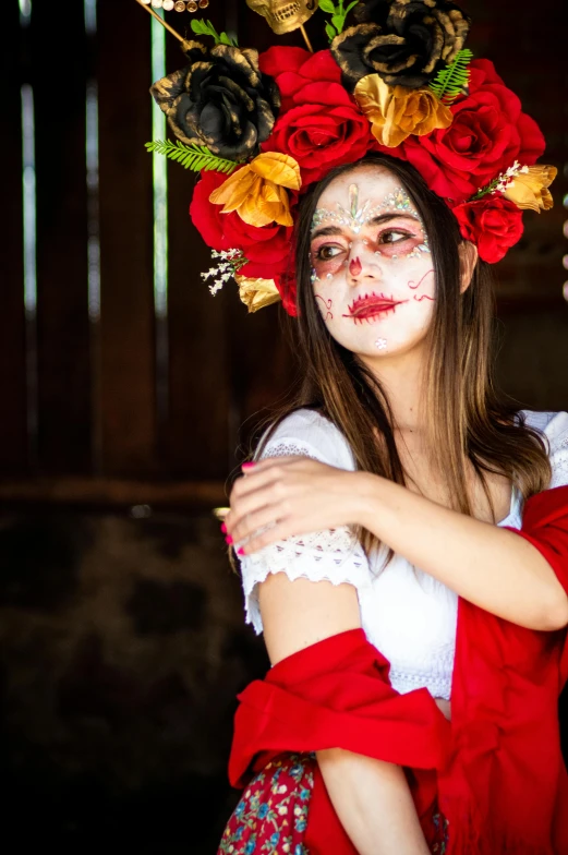 a woman in zombie makeup and flowers