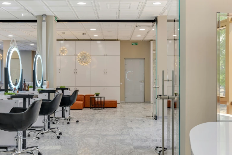 a large salon has glass doors and chairs in it