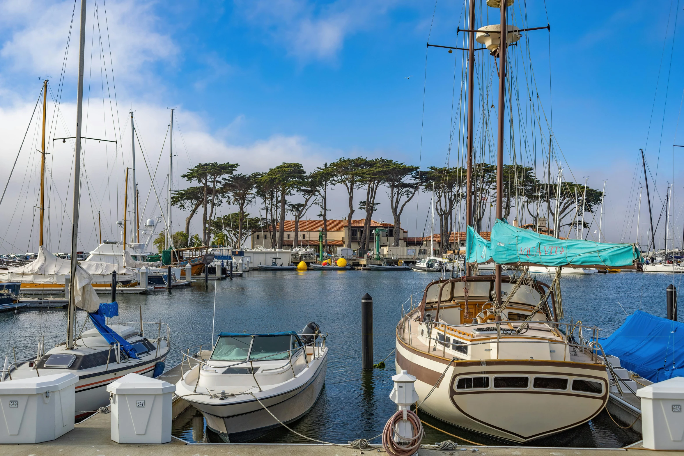 a marina with sail boats docked in the water