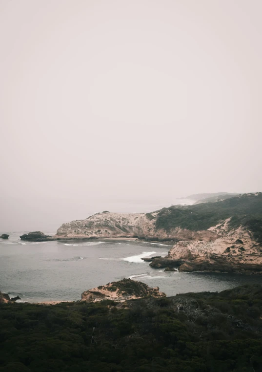 a calm bay with small waves near the shoreline