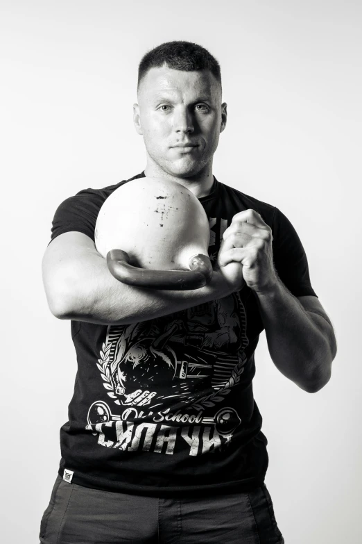 black and white pograph of a man posing with one arm in the air