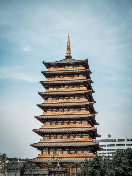 the tall tower of an asian building with several lights