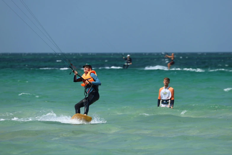 a group of people kite boarding in the ocean