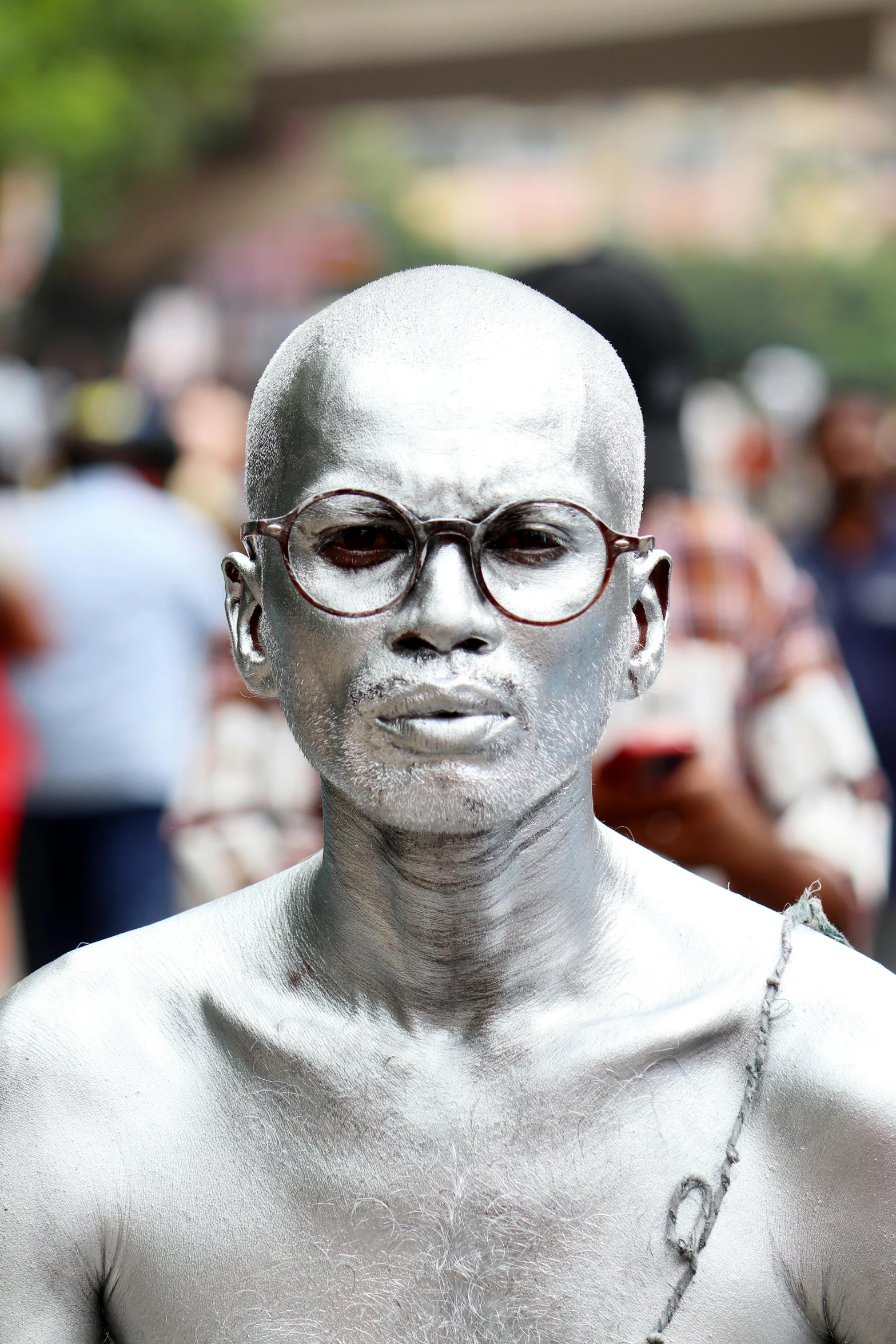 a man in an alien face paint make - up looks as if he's going to destroy someone