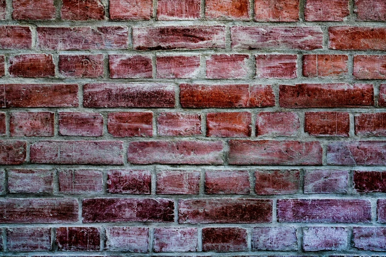a pink brick wall is made up of small square bricks
