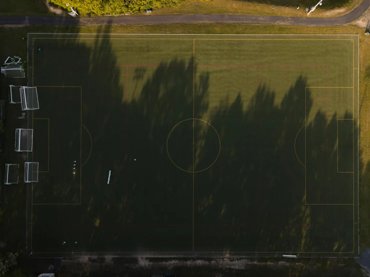 an empty sports field with a basketball court