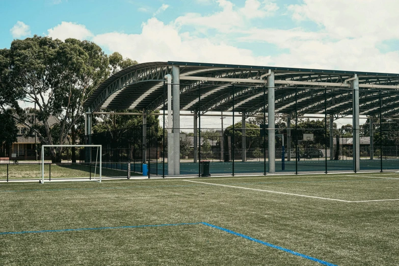 a view from the side, of a tennis court with a goal and a ball sitting in the middle