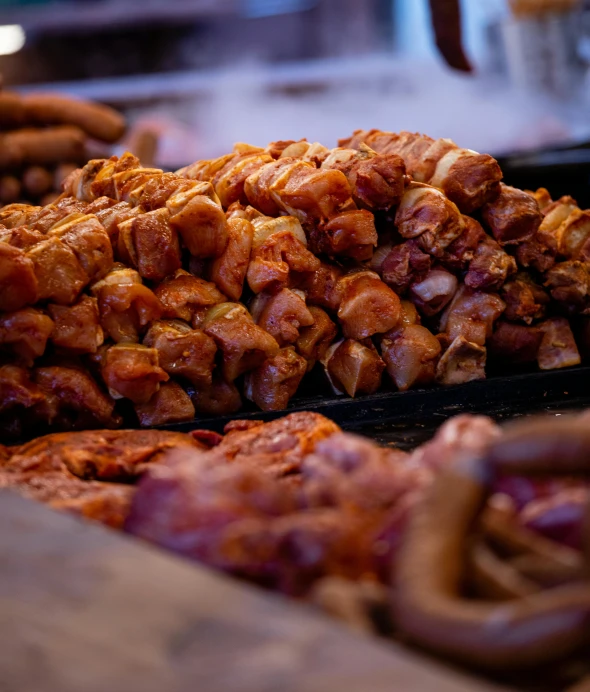 a plate full of meat and sausage sitting on top of a table