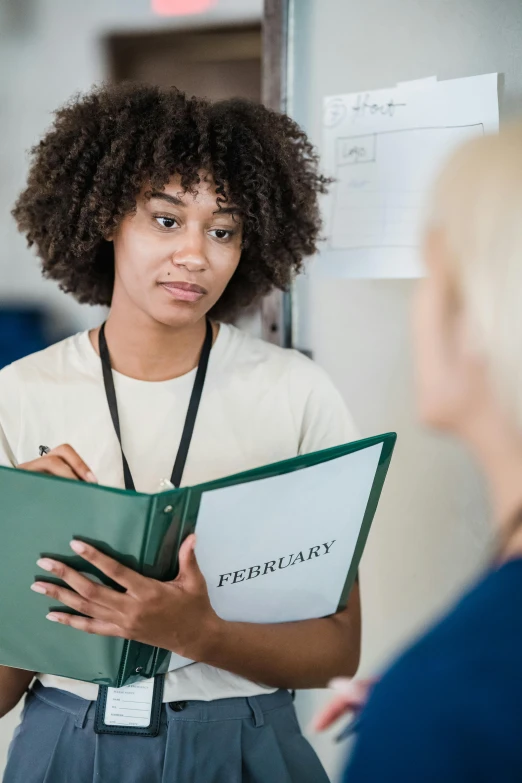 a woman stands next to an instructor in a classroom