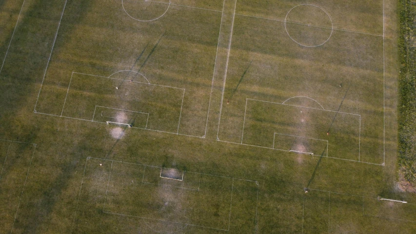 two men standing on a green field in the middle of a soccer field